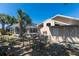 Backyard view showcasing the home's exterior, storage shed, screened-in pool area, and established landscaping at 181 Sportsman Rd, Rotonda West, FL 33947