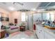Bright bathroom featuring double vanity, bathtub, shower and neutral tiling at 181 Sportsman Rd, Rotonda West, FL 33947