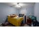 Bedroom featuring a bed, yellow bedspread, and natural light from a window at 181 Sportsman Rd, Rotonda West, FL 33947