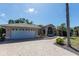 Charming single-Gathering home with a two-car garage and well-manicured landscaping at 181 Sportsman Rd, Rotonda West, FL 33947