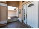 Covered front porch showcases a tiled floor, decorative fountain, and direct access to the home's entrance at 181 Sportsman Rd, Rotonda West, FL 33947