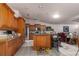 Spacious kitchen with wood cabinets, granite countertops, stainless steel appliances, and an eat-in island at 181 Sportsman Rd, Rotonda West, FL 33947