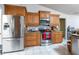 Modern kitchen featuring stainless steel appliances, granite countertops, custom cabinetry, and tile flooring at 181 Sportsman Rd, Rotonda West, FL 33947