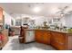 Open concept kitchen with granite counters, stainless appliances, and tile floors seamlessly connect to living area at 181 Sportsman Rd, Rotonda West, FL 33947