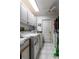 Laundry room featuring white appliances, tile flooring, and ample storage space at 181 Sportsman Rd, Rotonda West, FL 33947