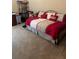 Bedroom with daybed featuring red and white bedding at 4041 Murfield E Dr, Bradenton, FL 34203