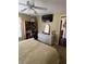 Well-lit bedroom boasting a large dresser, ceiling fan and television at 4041 Murfield E Dr, Bradenton, FL 34203