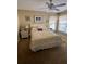 Cozy bedroom featuring a comfortable bed, ceiling fan, and lots of natural light from the windows at 4041 Murfield E Dr, Bradenton, FL 34203