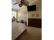 Bedroom featuring a dark wood dresser, ceiling fan and television at 4041 Murfield E Dr, Bradenton, FL 34203