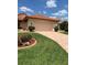 Charming single-story home with a tile roof, paver driveway, and beautifully landscaped front yard at 4041 Murfield E Dr, Bradenton, FL 34203