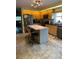 A bright kitchen with wooden cabinets, granite countertops, and modern stainless steel appliances at 4041 Murfield E Dr, Bradenton, FL 34203