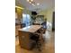 Kitchen showcasing an island with seating, wooden cabinets, and view to backyard at 4041 Murfield E Dr, Bradenton, FL 34203