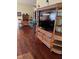 Comfortable living room featuring hardwood floors and a large entertainment center at 4041 Murfield E Dr, Bradenton, FL 34203