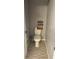 Small bathroom featuring standard toilet with storage basket on the wall at 4749 Stoneview Cir, Oldsmar, FL 34677