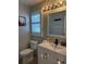Clean bathroom with shuttered window, modern vanity, and stylish light fixture at 4749 Stoneview Cir, Oldsmar, FL 34677
