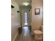 Bathroom with shower, toilet, and a door with window to the backyard at 4749 Stoneview Cir, Oldsmar, FL 34677