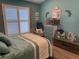 Cozy bedroom featuring shuttered windows, turquoise walls, and nautical decorations at 4749 Stoneview Cir, Oldsmar, FL 34677