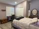 Cozy bedroom features wood-look floors, natural light, and a calming color scheme at 4749 Stoneview Cir, Oldsmar, FL 34677