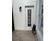 Exterior view of a white door, brick patio, and garden, adding a touch of charm to the outdoor space at 4749 Stoneview Cir, Oldsmar, FL 34677