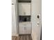 Hallway featuring storage cabinets with tile backsplash at 4749 Stoneview Cir, Oldsmar, FL 34677