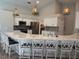 Modern kitchen with white cabinets, stainless steel appliances, granite countertops, and barstool seating at 4749 Stoneview Cir, Oldsmar, FL 34677