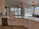 This open kitchen boasts a farmhouse sink, stainless steel appliances, and views of the pool area at 4749 Stoneview Cir, Oldsmar, FL 34677