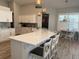 Modern kitchen with large island and barstool seating, updated appliances, and contemporary lighting at 4749 Stoneview Cir, Oldsmar, FL 34677