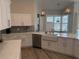 A bright kitchen featuring stainless steel appliances and a farmhouse sink at 4749 Stoneview Cir, Oldsmar, FL 34677