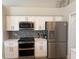This kitchen has white cabinets, stainless appliances, and plenty of countertop space at 4749 Stoneview Cir, Oldsmar, FL 34677