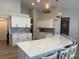 Modern kitchen with a large island and barstool seating, updated appliances, and contemporary lighting at 4749 Stoneview Cir, Oldsmar, FL 34677