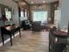 Inviting living room featuring wood-look tile floors, dark walls, and comfortable seating at 4749 Stoneview Cir, Oldsmar, FL 34677