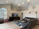 Spacious living room featuring a large black leather sectional, modern decor, and shuttered windows at 4749 Stoneview Cir, Oldsmar, FL 34677