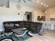 This bright living room includes a large, comfortable sectional sofa and an open layout with kitchen access at 4749 Stoneview Cir, Oldsmar, FL 34677