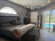 Serene primary bedroom featuring natural light, ceiling fan, and access to the pool area at 4749 Stoneview Cir, Oldsmar, FL 34677