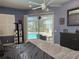 Comfortable primary bedroom with a view of the pool and access to the lanai at 4749 Stoneview Cir, Oldsmar, FL 34677