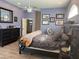 Spacious primary bedroom with dark furniture, ceiling fan, and blue-painted walls at 4749 Stoneview Cir, Oldsmar, FL 34677