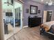 Primary bedroom showing lanai access, dark furniture, and serene, blue decor at 4749 Stoneview Cir, Oldsmar, FL 34677