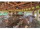Spacious outdoor venue featuring long tables and a bar area decorated with ceiling fans and decorative banner flags at 4749 Stoneview Cir, Oldsmar, FL 34677