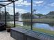 Enjoy picturesque waterfront views from this screened-in porch overlooking a serene pond and fountain at 4749 Stoneview Cir, Oldsmar, FL 34677