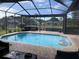 Sparkling pool with an inflatable raft is surrounded by a screened-in patio and lush landscaping for ultimate relaxation at 4749 Stoneview Cir, Oldsmar, FL 34677