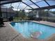 Relaxing screened-in pool features clear blue water, an inflatable raft, and brick pool deck perfect for sunny days at 4749 Stoneview Cir, Oldsmar, FL 34677