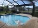 Inviting screened-in pool area with a comfortable seating area and serene backyard view at 4749 Stoneview Cir, Oldsmar, FL 34677