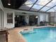 Enjoy the Florida lifestyle with this screened pool and patio featuring a grill and outdoor seating area at 4749 Stoneview Cir, Oldsmar, FL 34677