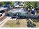 Aerial view of the property with a well-manicured front lawn, fenced backyard, and a convenient driveway at 7226 13Th N St, St Petersburg, FL 33702