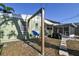 Backyard with a swing set, grill, and a screened in porch with string lights at 7226 13Th N St, St Petersburg, FL 33702