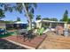 View of the backyard with dining table, chairs, play set, and chicken coop at 7226 13Th N St, St Petersburg, FL 33702