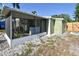View of the backyard and screened patio with light green exterior at 7226 13Th N St, St Petersburg, FL 33702