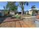 View of the backyard featuring a dining set, shed, and swing set, perfect for outdoor activities at 7226 13Th N St, St Petersburg, FL 33702