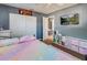 This bedroom is cute and cozy with gray walls, white trim, and a TV at 7226 13Th N St, St Petersburg, FL 33702