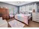 Charming bedroom with soft rug, comfortable bed, ample dresser space, and a ceiling fan at 7226 13Th N St, St Petersburg, FL 33702